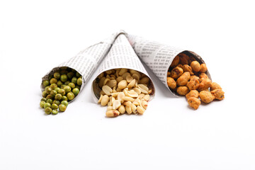 Indian snack, dry spicy nuts in paper cone on white background. - obrazy, fototapety, plakaty