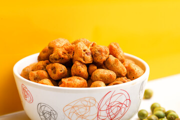 Roasted coated peanuts on white background. Delicious snack peanut.