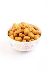 Roasted coated peanuts on white background. Delicious snack peanut.