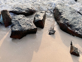 Rocks and grains of sand on the beach.