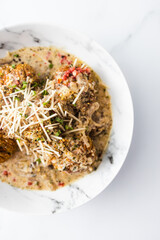 healthy plant-based food, vegan potato bake with dairy-free creamy sauce with chives nutmeg and herbs