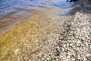 clear lake water with pebble beach, close-up