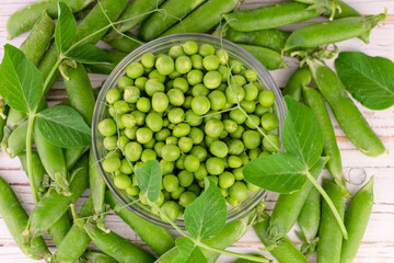 Green peas in a glass bowl. Close-up. Flat lay.
