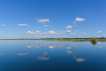 Large island in the lake. There is a beautiful cloud reflecting on the water At  Bueng Kan Province of Thailand 3