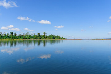 Large island in the lake. There is a beautiful cloud reflecting on the water At  Bueng Kan Province of Thailand 5
