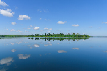 Large island in the lake. There is a beautiful cloud reflecting on the water At  Bueng Kan Province of Thailand
