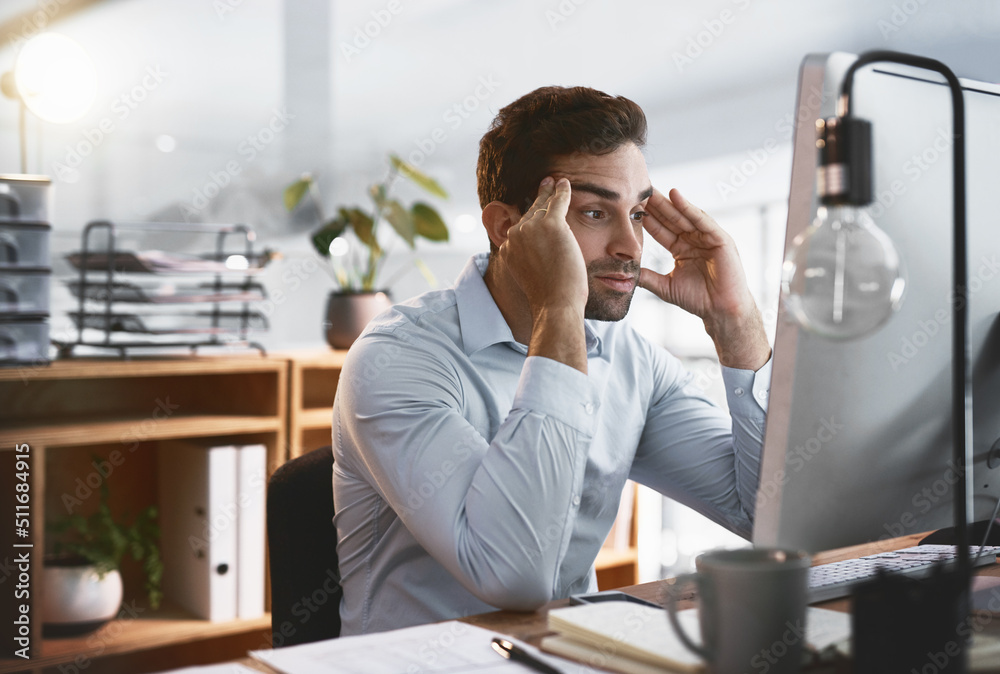Poster im trying so hard not to lose my mind. shot of a young businessman looking stressed out while workin