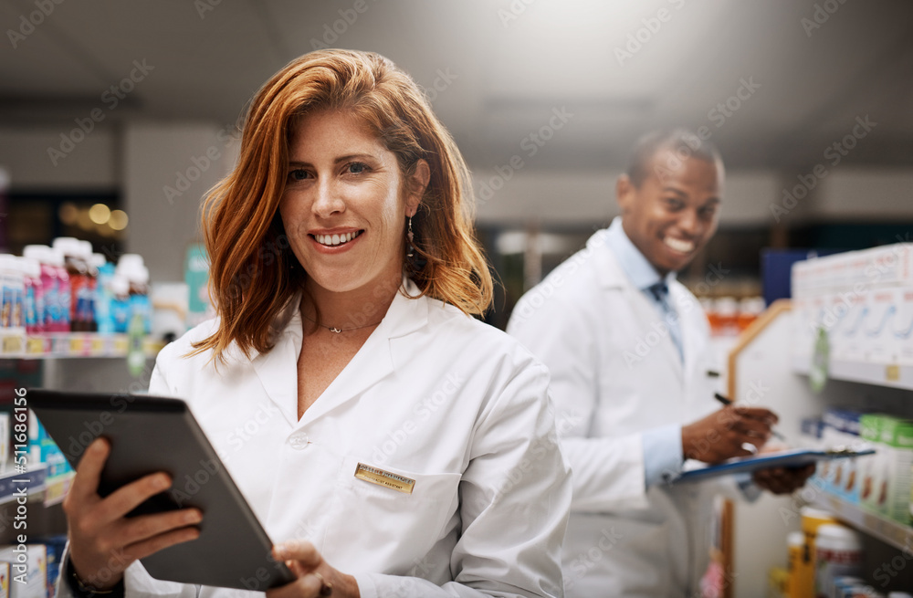 Poster were open 24 hours for your convenience. portrait of two pharmacists working together in a chemist.