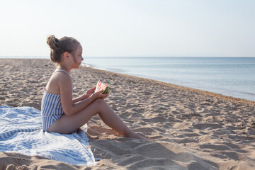 Small child girl in blue and white swimwear resting on sea beach, summer vacation and holidays concept