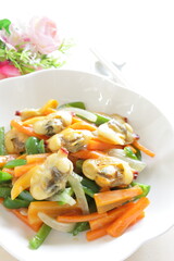 Chinese food, clam and mixed vegetable stir fried on white plate