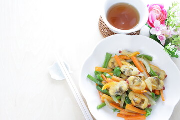 Chinese food, clam and mixed vegetable stir fried on white plate