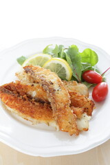 Homemade bread crumbs sardines fillet fried served with baby leaves and cherry tomato