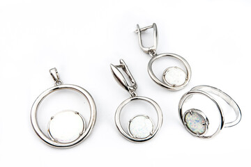 Silver jewelry set of ring and silver earrings with stones on white background. Silver jewelry set collection