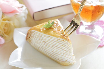 Piece of crepe cake with mint for tea break food