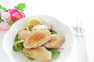 Asian food, Chinese pan fried chicken wings on  baby leaves