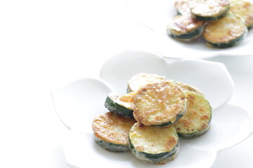 Korean food, fried zucchini slices on dish for comfort food image