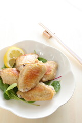 Asian food, Chinese pan fried chicken wings on  baby leaves