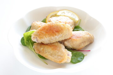 Asian food, Chinese pan fried chicken wings on  baby leaves