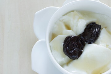 Dried plum and honey on Yogurt for healthy dessert and breakfast
