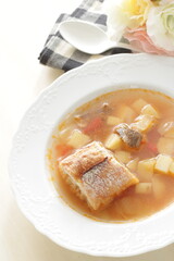 Homemade minestrone soup served with French bread