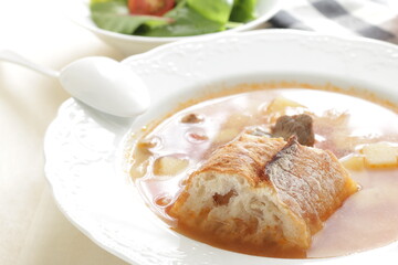 Homemade minestrone soup served with French bread and salad