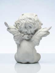 Obraz premium plaster white statuette in the form of an angel on a white background