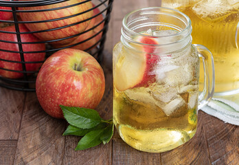 Glass of apple juice with red apples