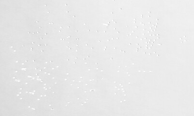 Small holes in white paper, isolated