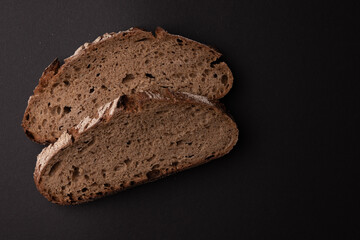 slices of rye bread isolated on black background, top view