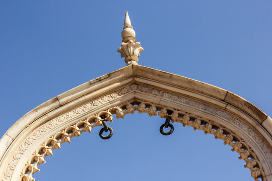 An ancient marble arch against a blue sky at the royal palace in Deeg near Jaipur in Rajasthan, India.
