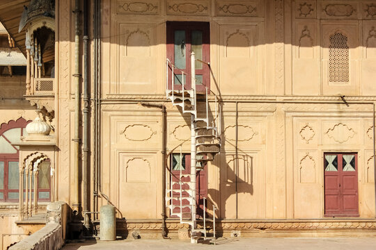 A spiral staircase outside the walls of the ancient royal palace of Deeg in Rajasthan, India.