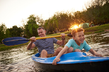 Obraz premium Off to adventure. Shot of a father and son rowing a boat together on a lake.