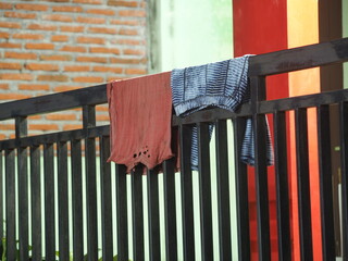 clothes are dried in front of the house on the fence at night, clothes for residential residents in...
