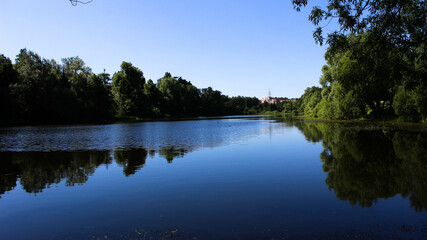 River with reflections of trees in the city park