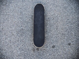 Skateboard from overhead angle on blacktop