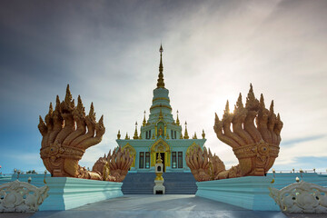 Beautiful relics and naga statue behind the blue sky on the evening in Wat Saensuk Suthi Wararam at...