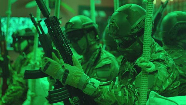 Group of Soldiers or Special Forces Loading weapons and installing Magazine Before Fight. Military, war or strike ball theme concept . waiting for game. Shot on ARRI Alexa cinema camera in Slow Motion