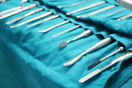 Surgical instruments, surgery, placed on a sterile green cloth, soft focus 
