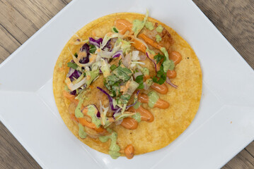 Overhead view of appetizing fish taco with perfect presentation for a tempting Mexican food delicacy