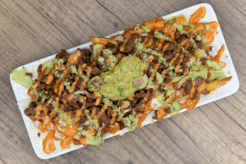 Overhead view of appetizing carne asada steak french fries for a tempting Mexican food delicacy