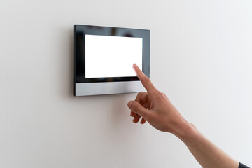 Woman using control panel with smart house app
