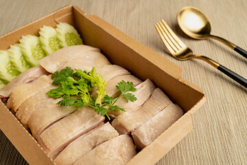 Hainanese Chicken rice (Singapore chicken rice) famous singapore food and Thai food on dark wood table. Asian food style.
