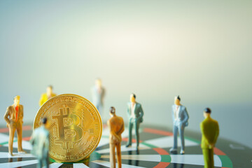 business miniature people standing around  bitcoin gold on dartboard hitting in the target center of dartboard  Target business success and investment and finance concepts.