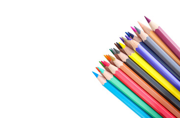 Naklejka premium colored pencils lined on a white background