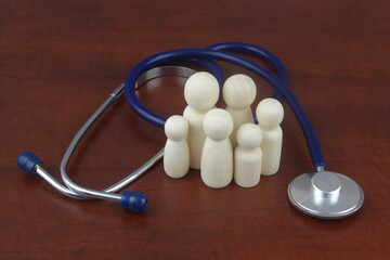 Medical insurance, family health care and family clinic concept. Family people figures with stethoscope.