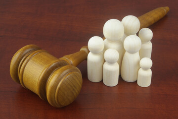 Family and laws concept. Judge gavel with people figures of family members close-up.