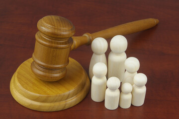 Family and laws concept. Judge gavel with people figures of family members close-up.