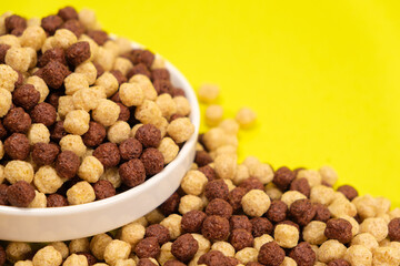 Corn sweet balls on a yellow background. Quick dry breakfasts, side view.