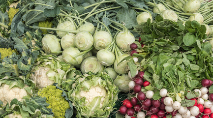 a variety of vegetables at a market stall