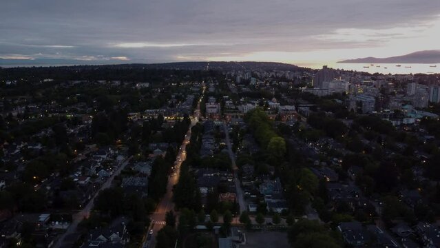Fly over the road at dusk in North American city houses with creek on background